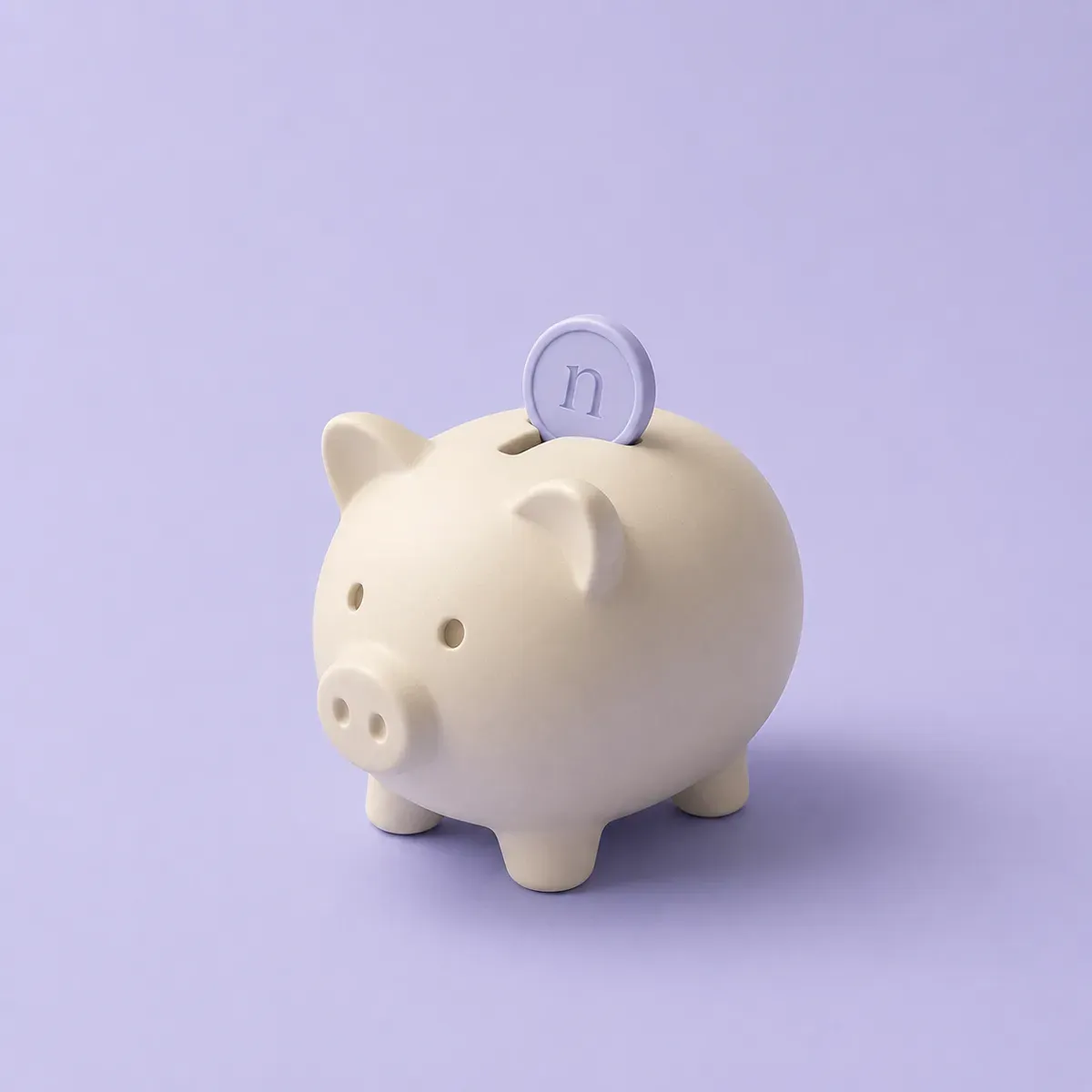 A ceramic piggy bank with a coin dropping into it